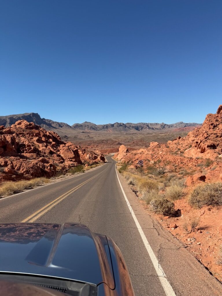 Driving along the road into the Valley of Fire State Park past red rock formations