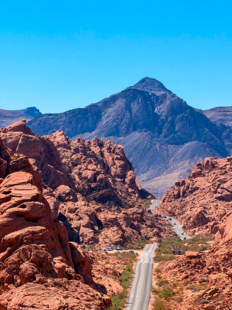 Mouse's Tank Road running towards the mountains through red rock in the Valley of Fire
