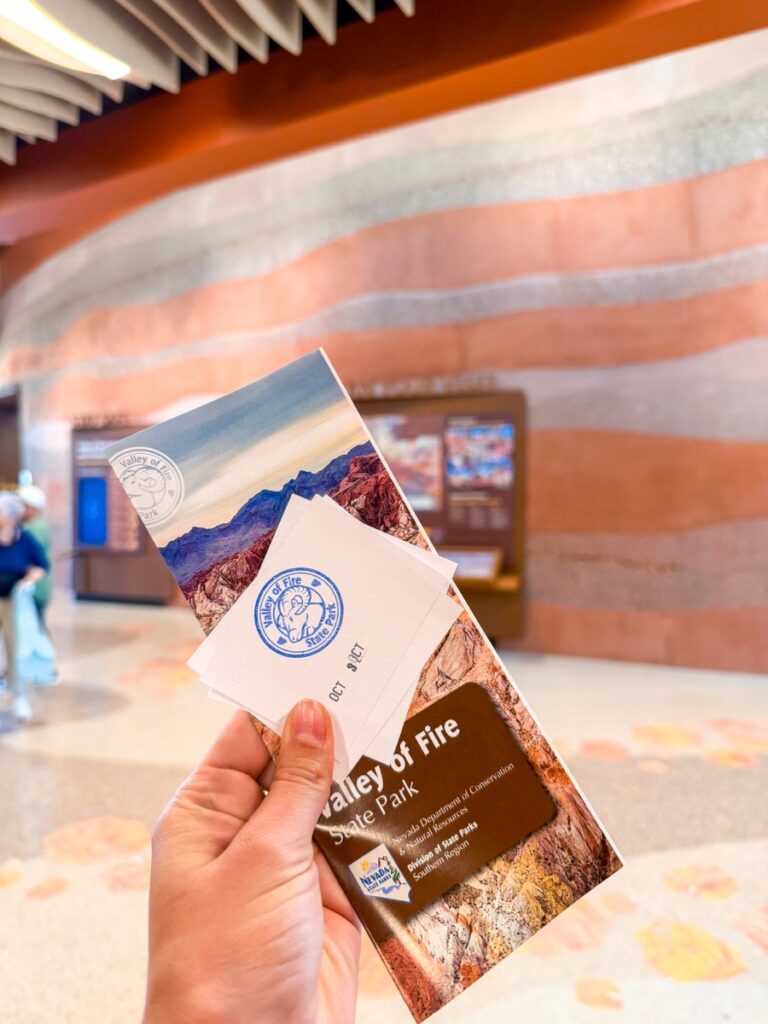 Holding the Valley of Fire State Park map and brochure inside the Visitor Center